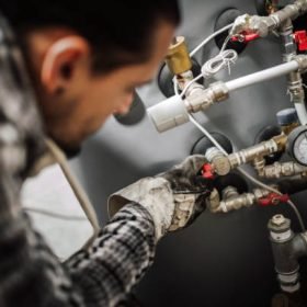 Close up photo of a man fixing the pipes at home.