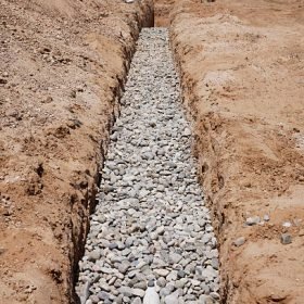 A new drain field filled with stones.