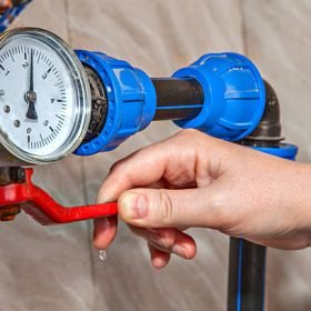 Water gauge pressure, hand shut off main valve, close-up.